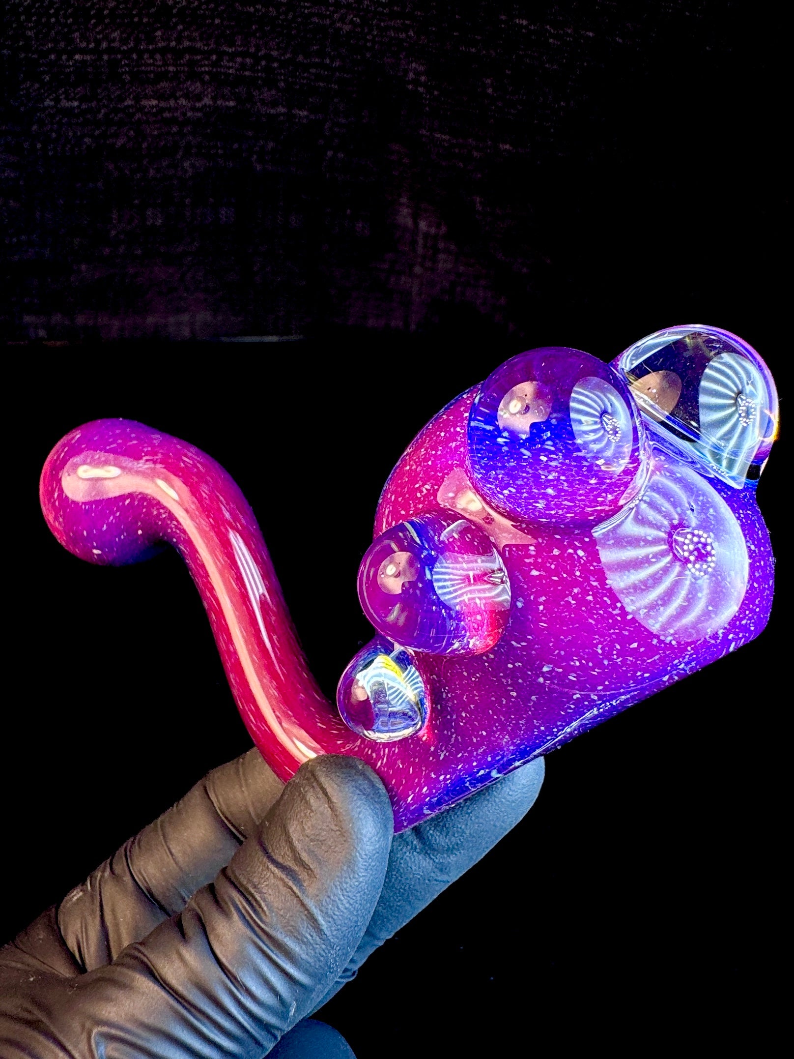 A Bendy/Sherlock shaped Glass Pipe that has Blue, Purple and Red Tones.