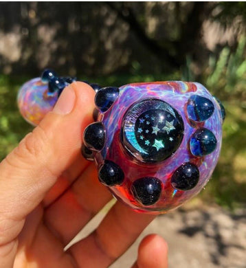 An amber purple glass pipe with a dichro moon and stars image. 