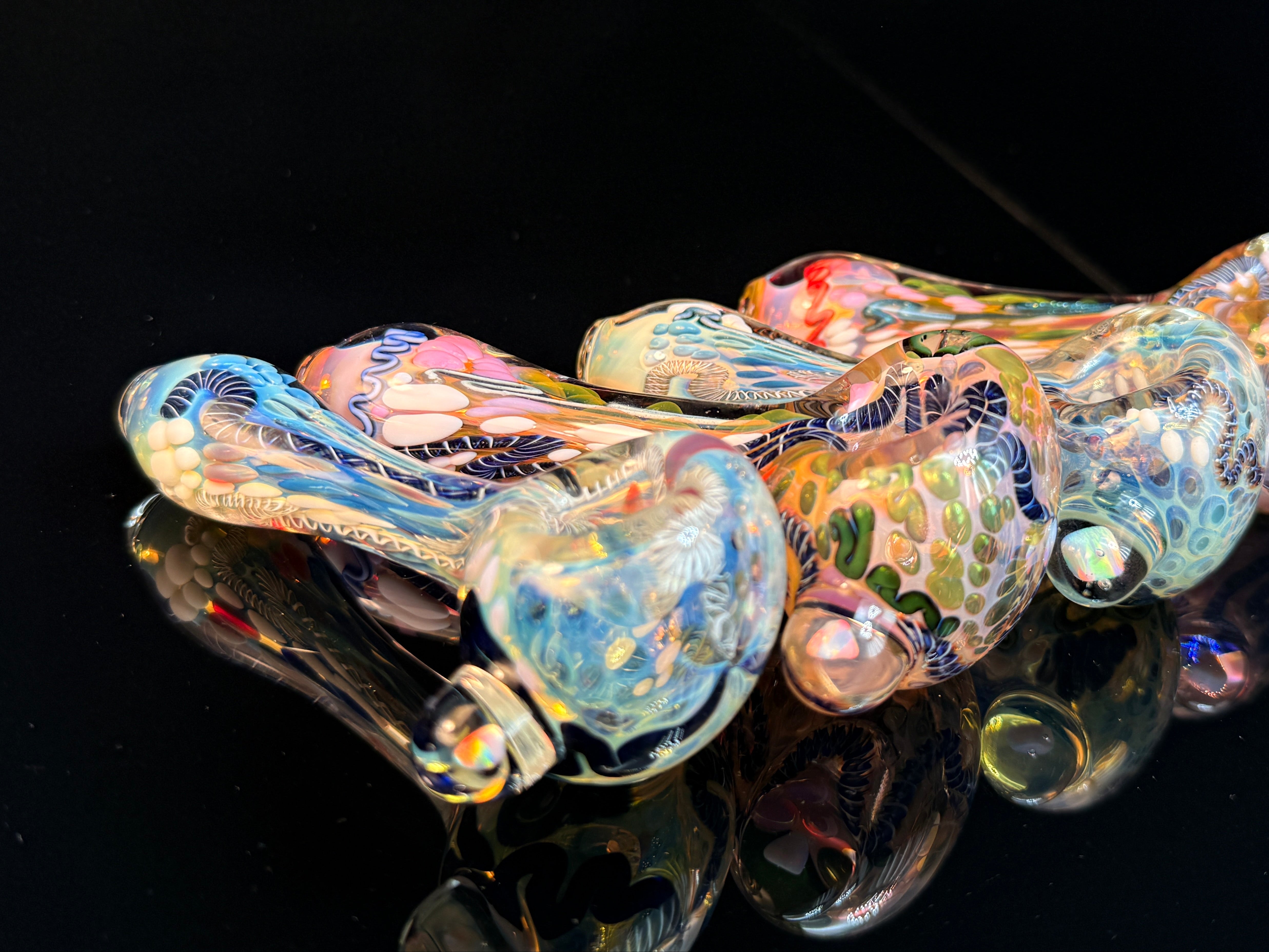 A picture of color changing, inside out glass pipes with opals.